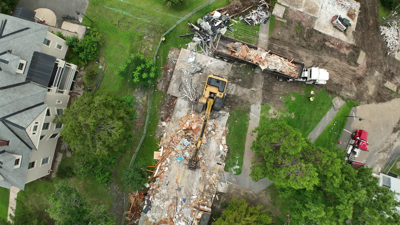 Aerial View of Building Demolition with Excavator and Debris Removal