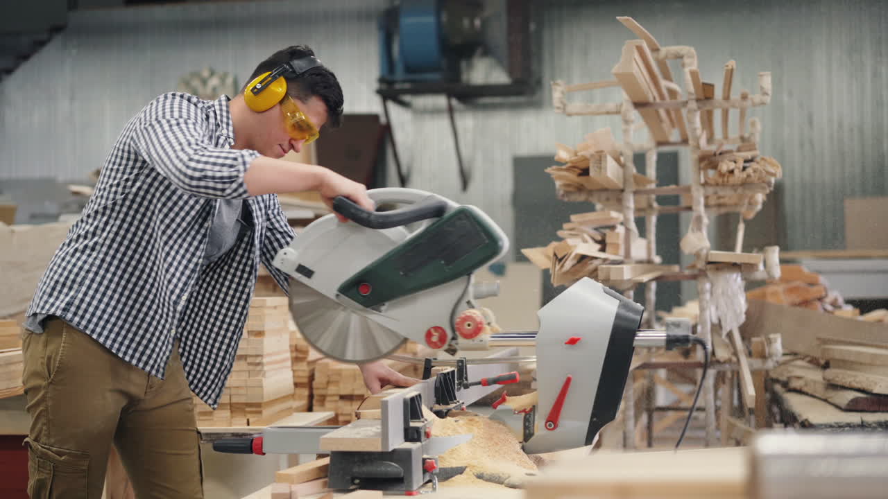 Carpenter Using Circular Saw in Workshop