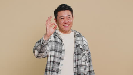 happy asian man showing ok gesture like sign positive feedback celebrate victory approve idea