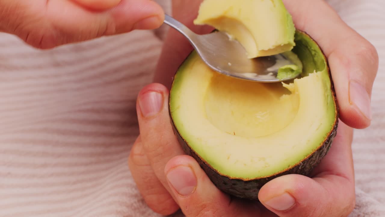 Person eating an avocado