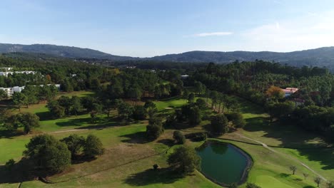 flying over green golf course in portugal