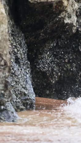 waves hitting rocks at ao nang beach