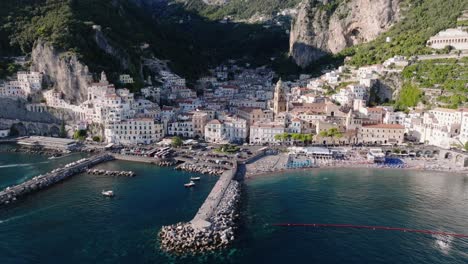 amalfi coast breakwaters with medieval town in the gulf of salerno, southern italy