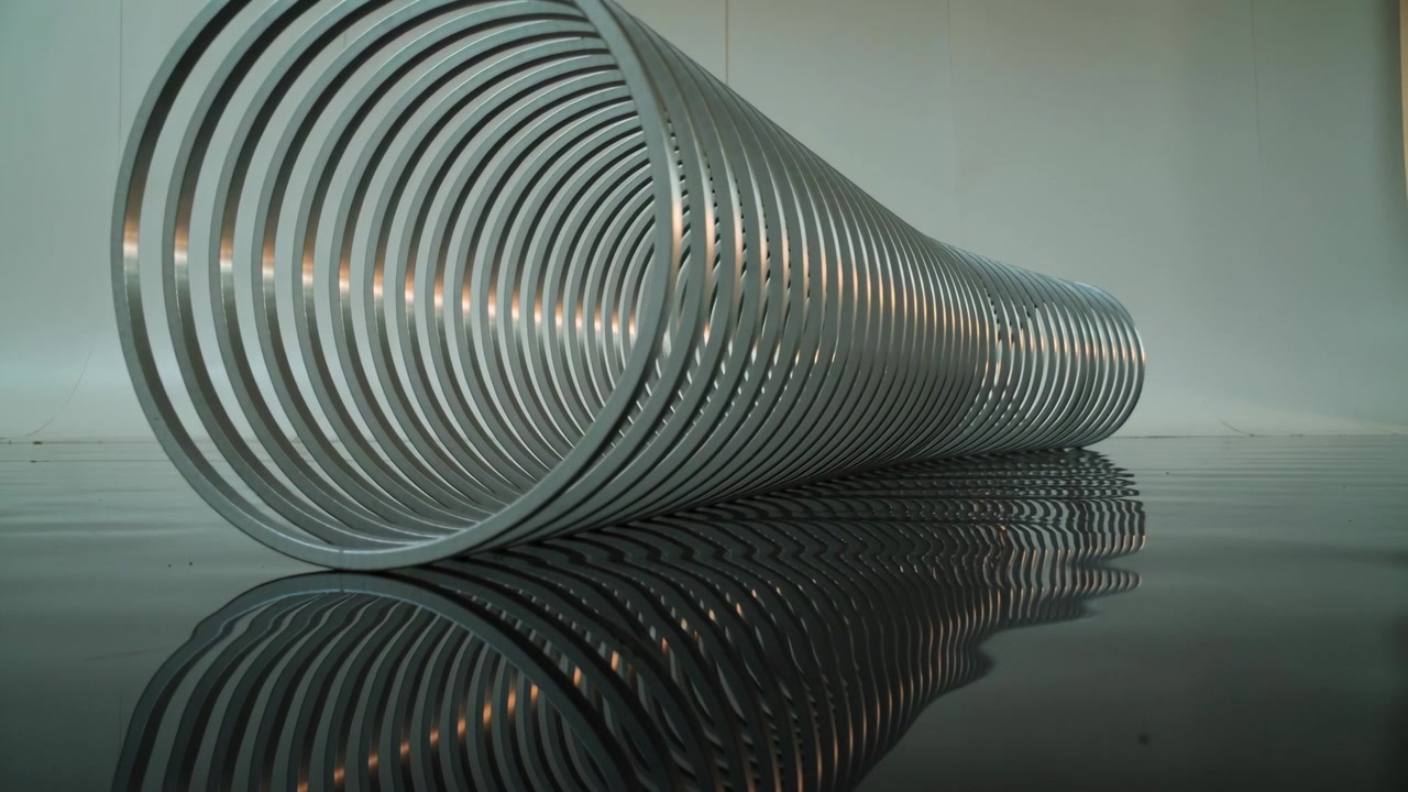 Metallic Spiral Sculpture Reflecting on a Dark Surface