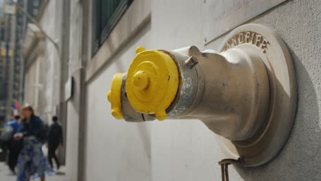 fire hydrant in the wall of a building on wall street in new york