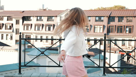 happy woman dancing on a rooftop