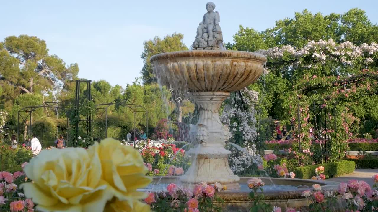 Ancient Cupid fountain in the Rosaleda rose garden in Madrid. Serene and picturesque garden scene.