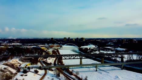 Winter-afternoon-aerial-flyover-snow-covered-North-Saskatchewan-River-Victoria-Kinsmen-Park-Briges-of-Dudley-B-Menzies-for-public-transit-rail-high-level-with-streetcar-track-modern-walter-dale-blu1-4
