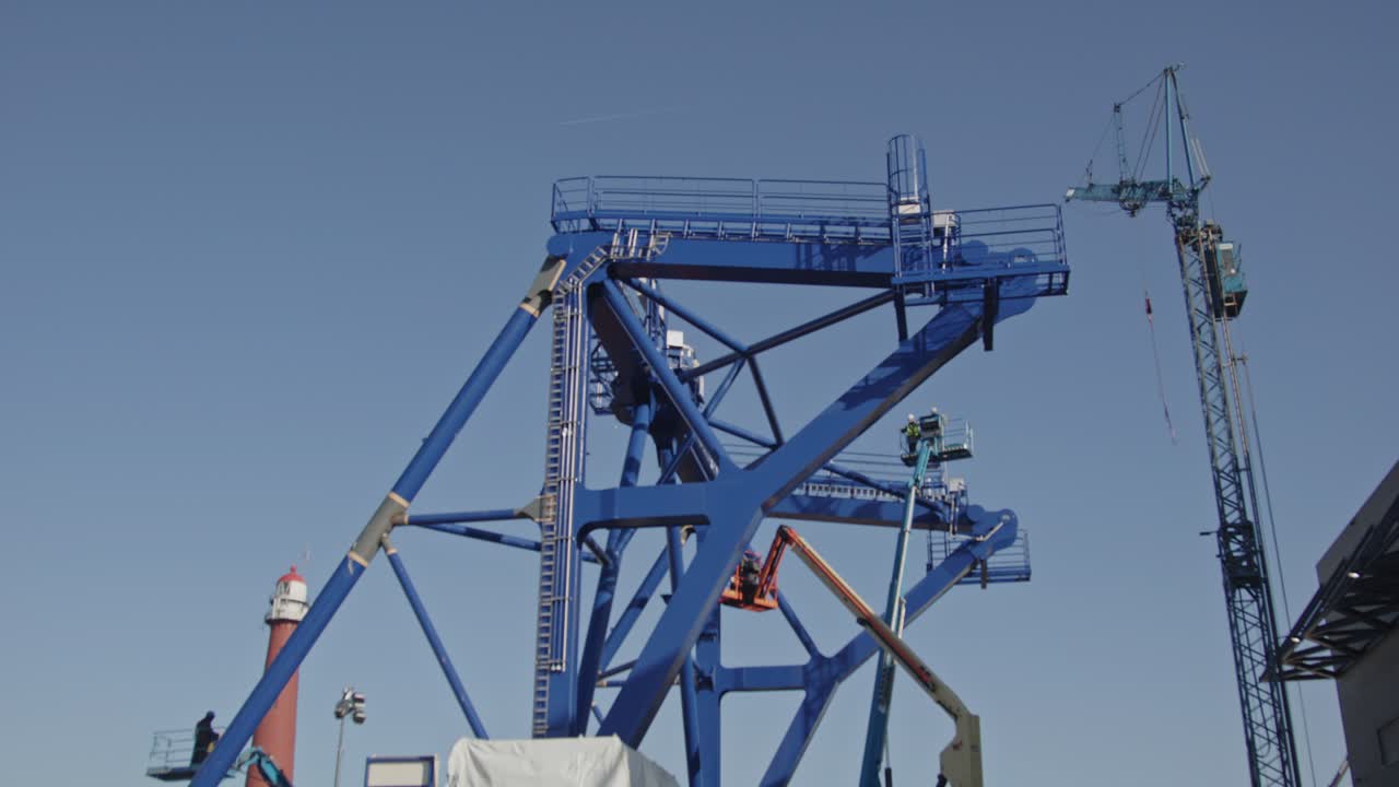 Beautiful tilt up of a pre-piling template being constructed at a dock in a harbor. The piling template will be used to place offshore wind turbines in deep water