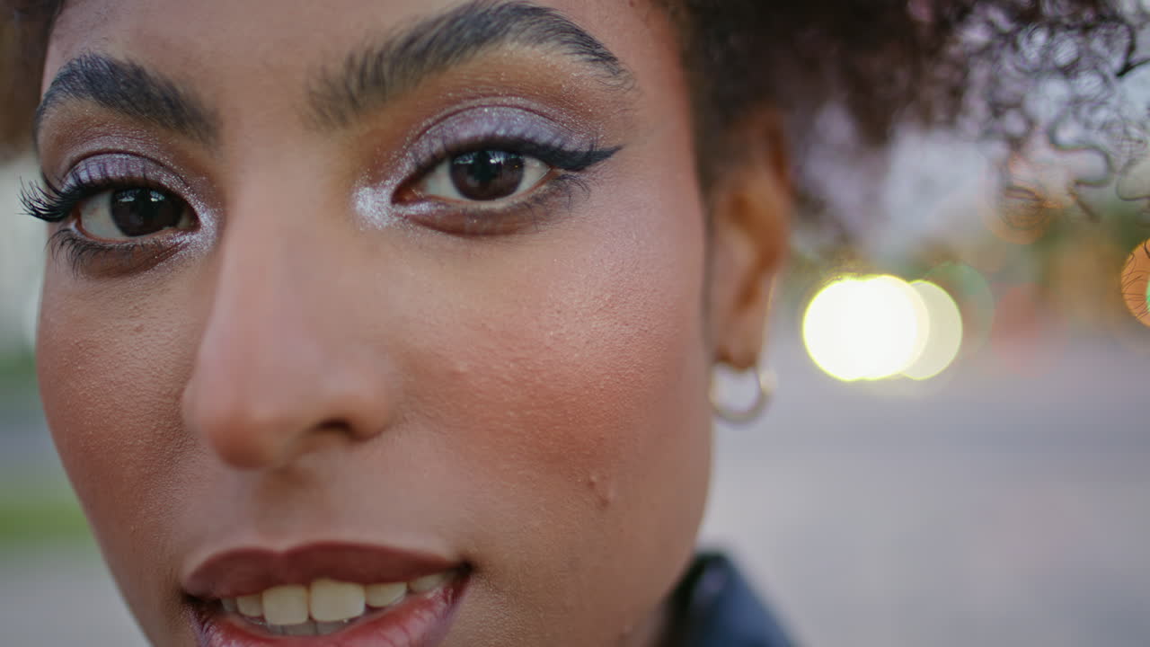 Closeup lady face with bright makeup. Gorgeous curly woman posing city