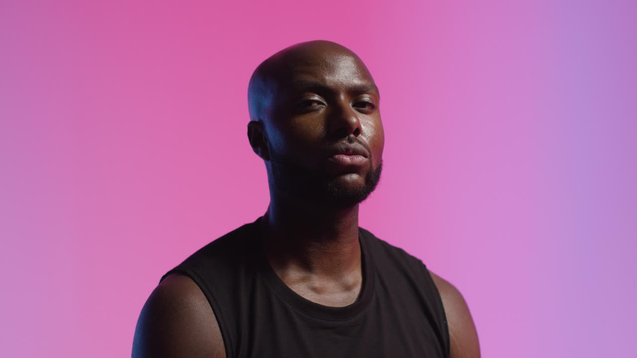 Studio Portrait Shot Of Male Athlete Wearing Sports Vest Against Pink Lit Background 1