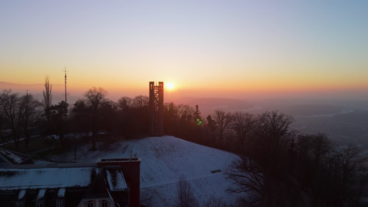 Droneshot flying into the sunset over the Gurtenpark during a winter evening