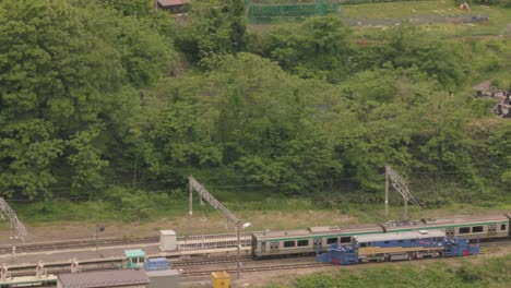 view from the top of yamadera temple looking back at the main train line through the rural town