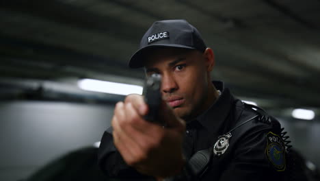 Policeman-aiming-target-with-gun.-Police-officer-holding-weapon-in-hands