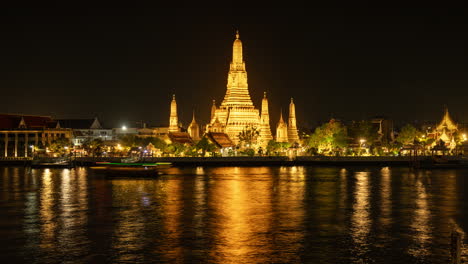 timelapse of the famous wat arun temple in bangkok on the river chao phraya at night