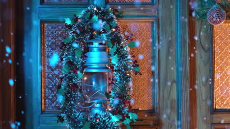 christmas lantern and garland decoration at home door with snow falling