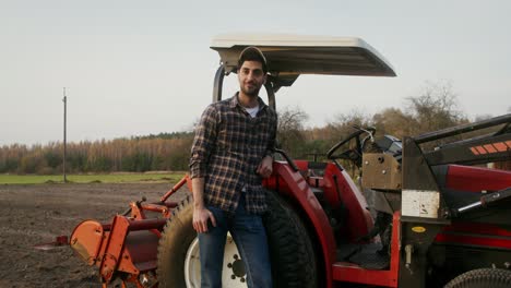 farmer by tractor in field