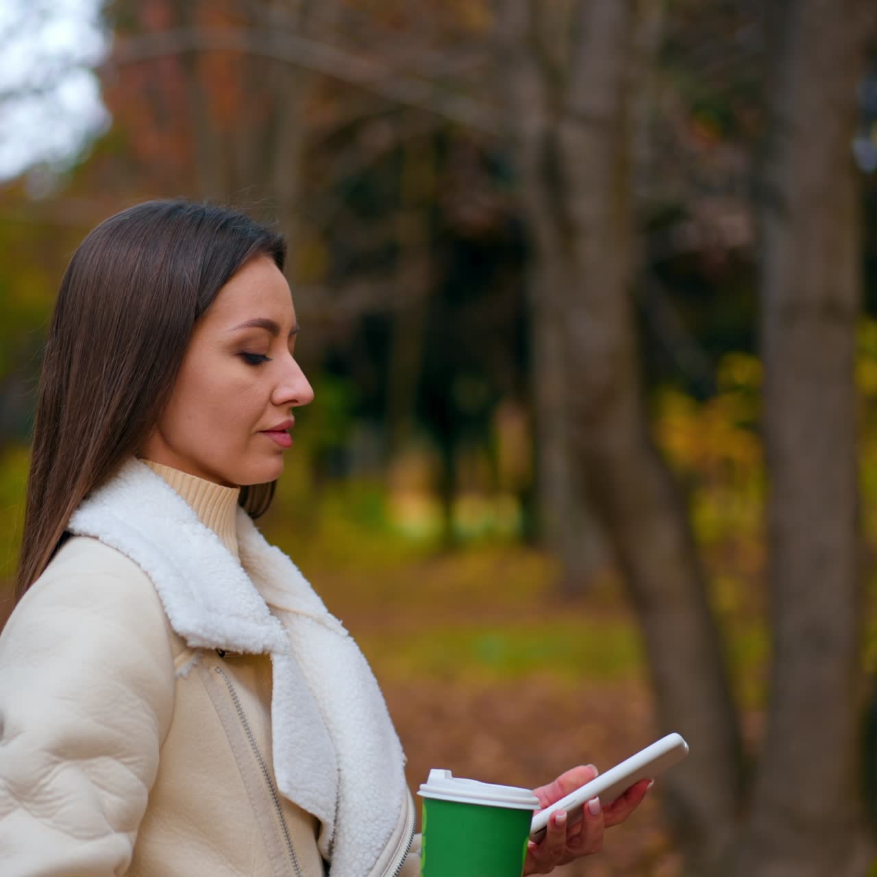 Pretty young woman awlking outdoor with coffee. Lifestyle young lady having coffee break