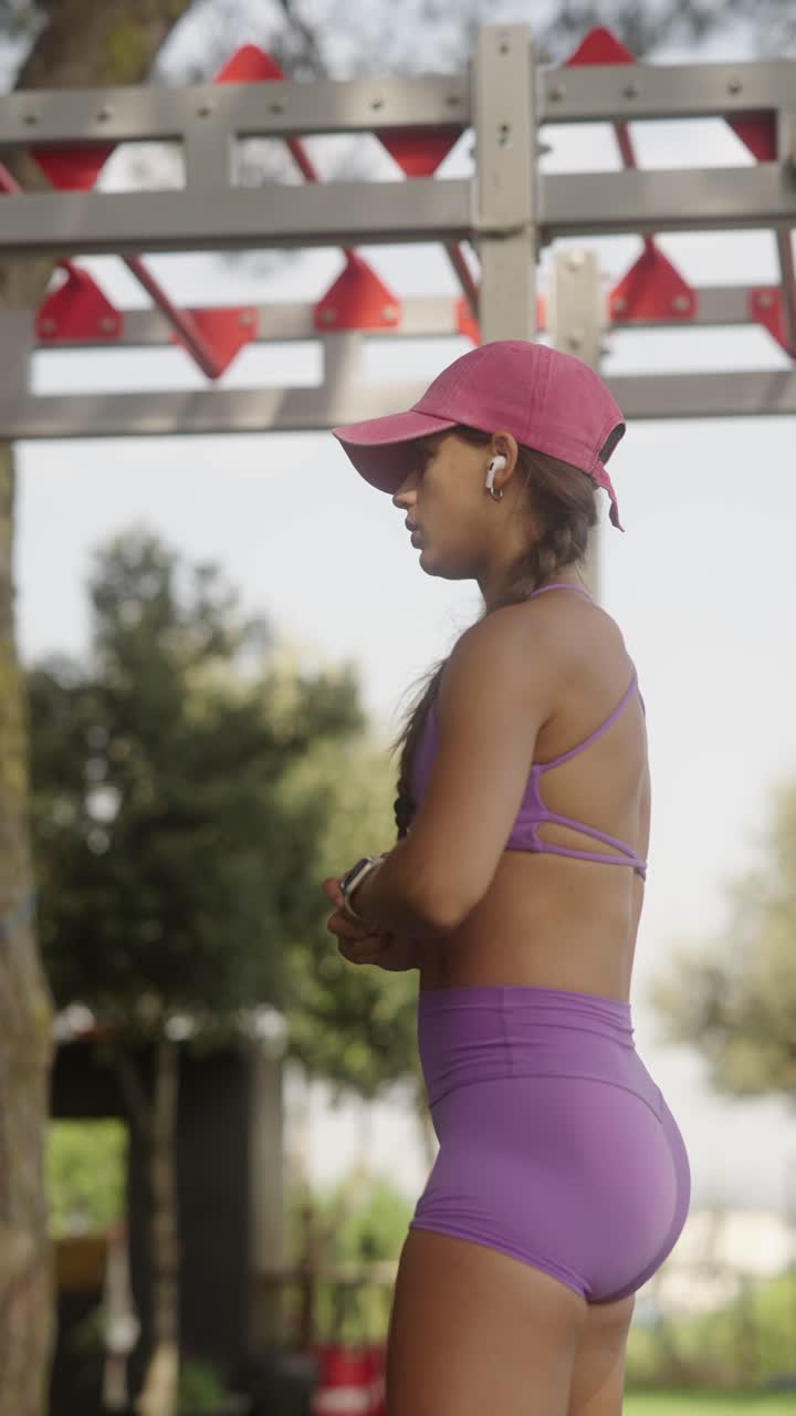 Fitness woman exercising with resistance band outdoors