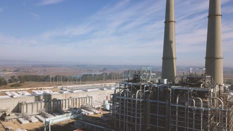 moss landing - california, usa. cinematic track forwards across energy facility. filmed on dji mavic pro