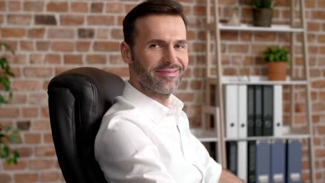 portrait of smiling businessman in his office