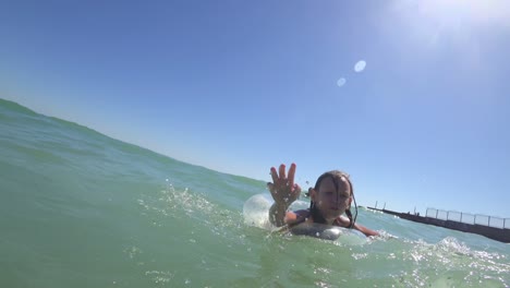 girl swims in the sea on a rubber ring