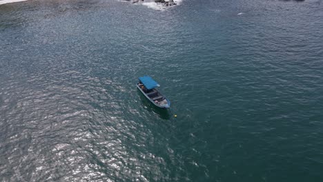 Establishing-Shot-Of-A-Single-Small-Fishing-Vessel-Near-To-Shore