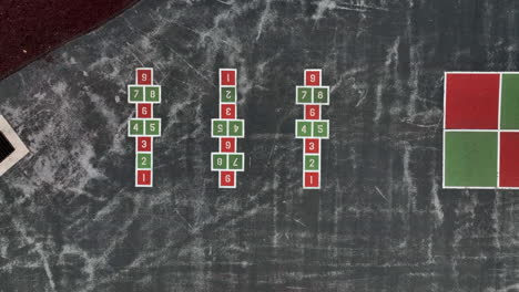 Top-down-aerial-of-hopscotch-and-four-square-at-school-recess-playground