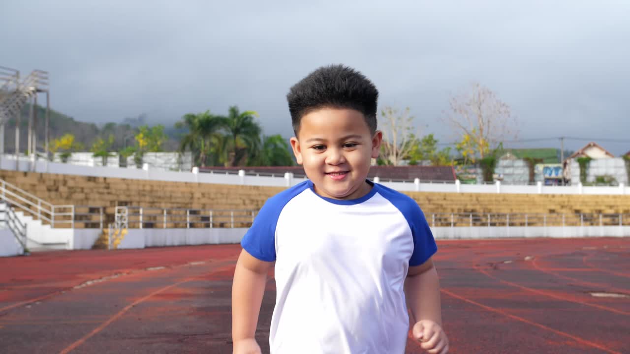 Cute Little Boy Running At Stadium