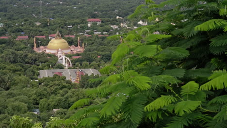 view to a burmese acadamy in myanmar with green leaves in front