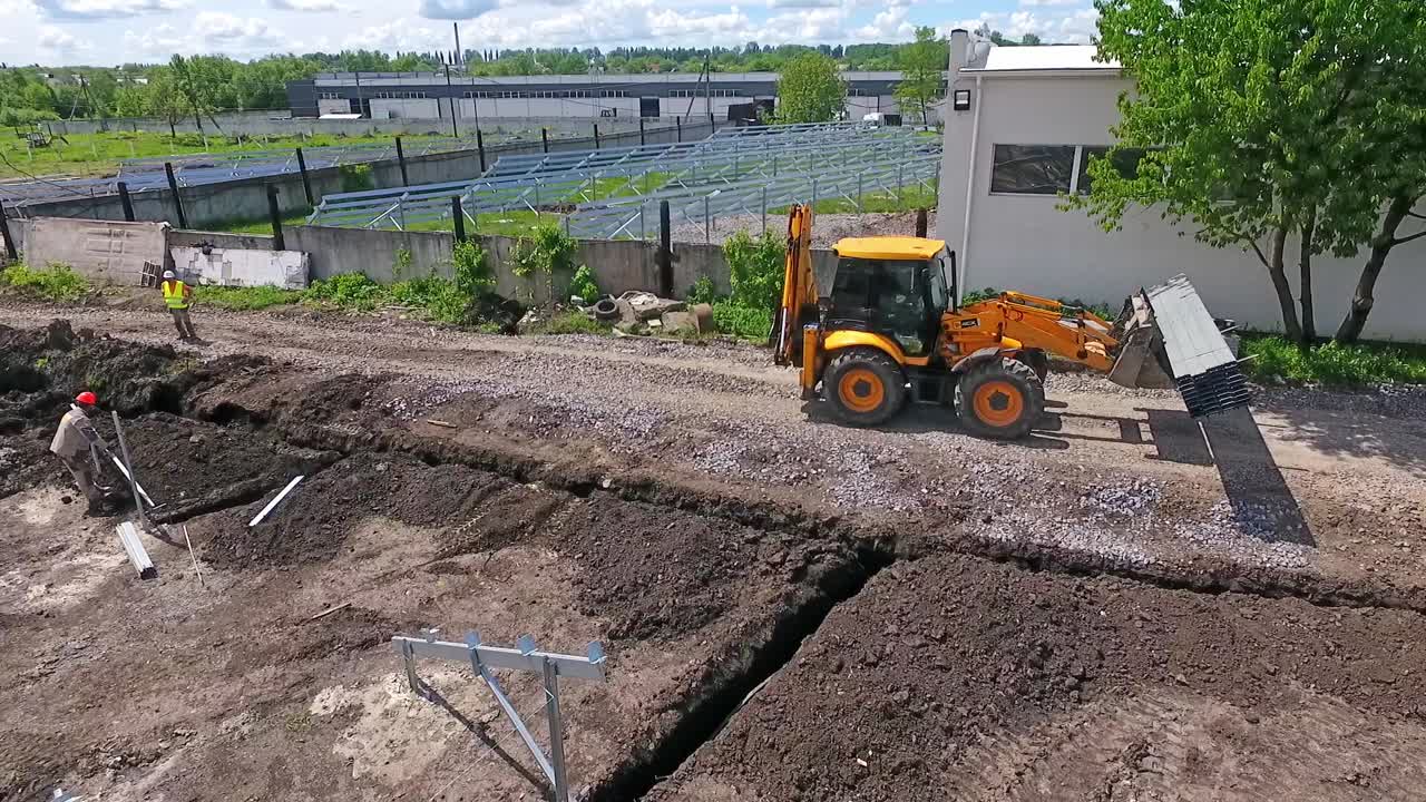 Excavator on construction site. Tractor excavator on construction site, aerial view