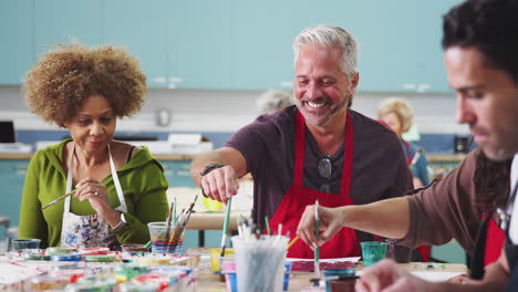 group of mature students attending art class in community centre