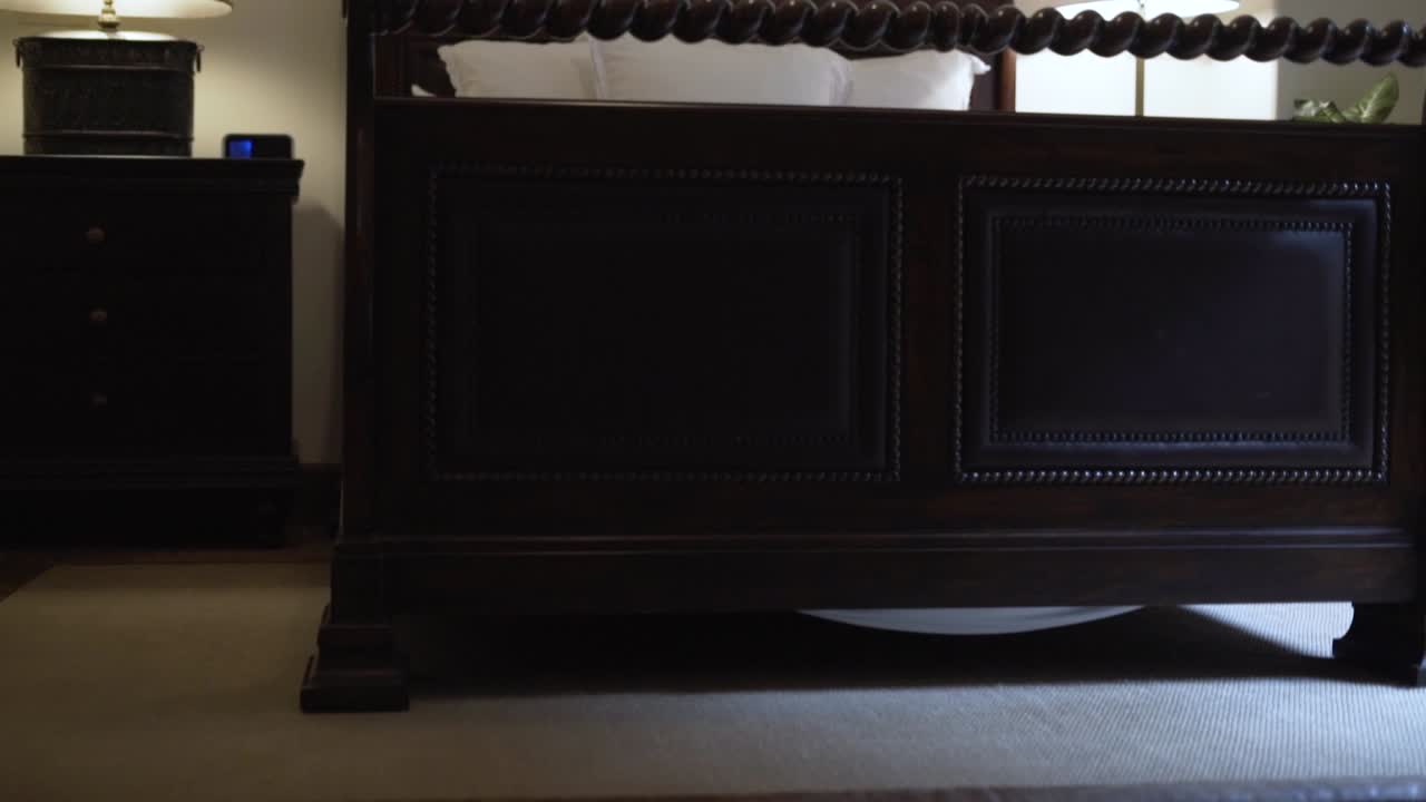 bed in the room with cushions and lamp on