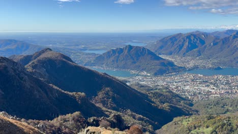 tilt-up reveal of mountainous landscape with lakes around monte resegone in lecco, italy