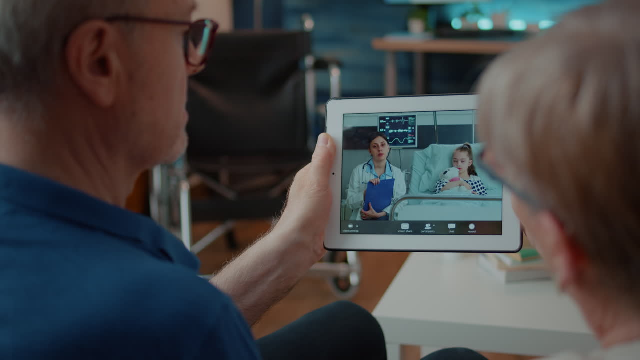 Family using telemedicine to video call a doctor and patient on a tablet