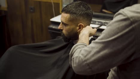 Barber-Shaves-Man's-Head-Using-Electric-Razor---close-up