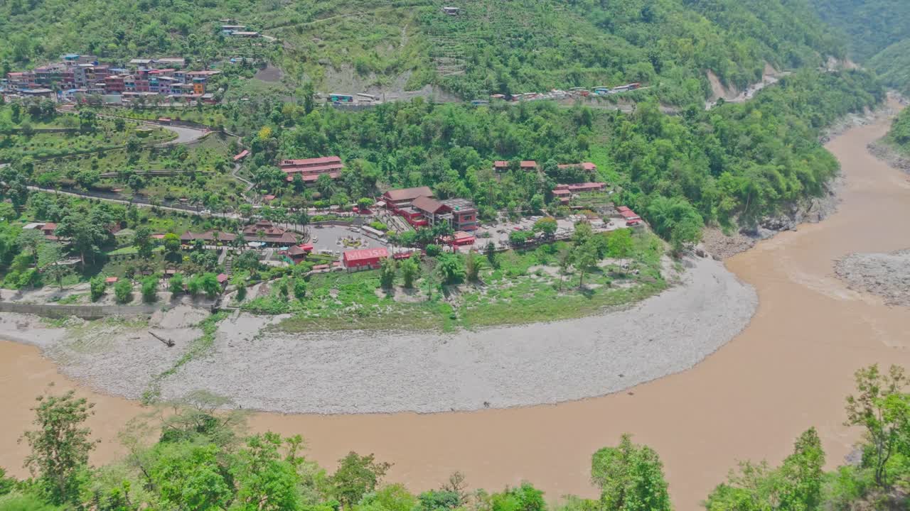 A cable car travels above a flowing river and lush green mountains, offering a stunning view of nature, elevation, and movement. Perfect for themes of travel, exploration, and scenic transportation