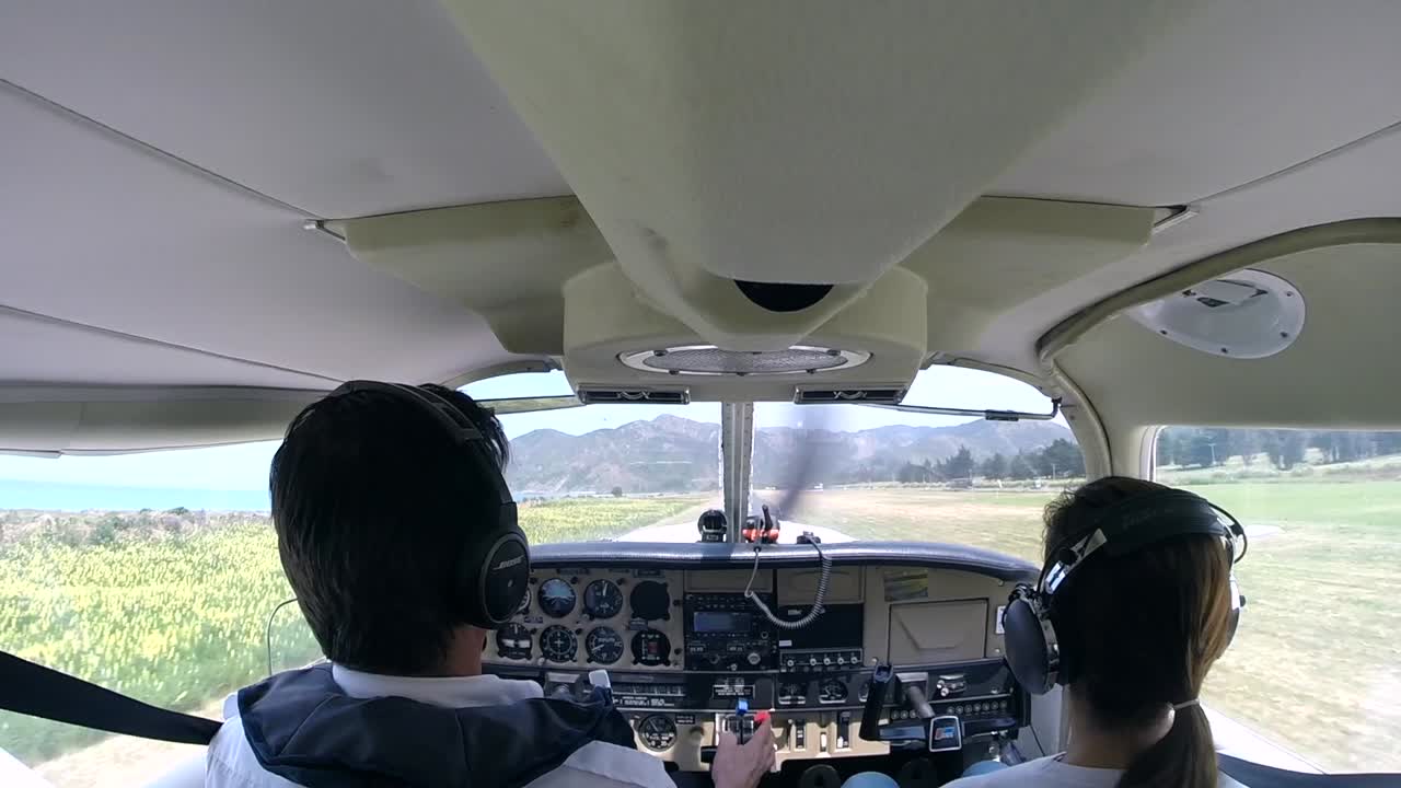 Cockpit view of pilots landing a small plane