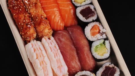 assortment of sushi in a wooden box