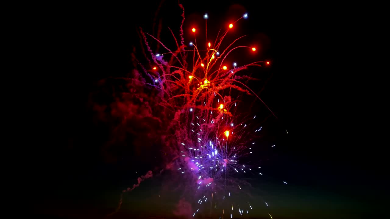 Sky only fireworks show with colorful explosions of light in the dark night, up close view