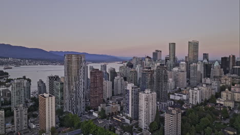 vancouver bc canada aerial v65 cinematic drone flyover west end residential neighborhood capturing downtown cityscape with towering high rise buildings at dusk - shot with mavic 3 pro cine - july 2023