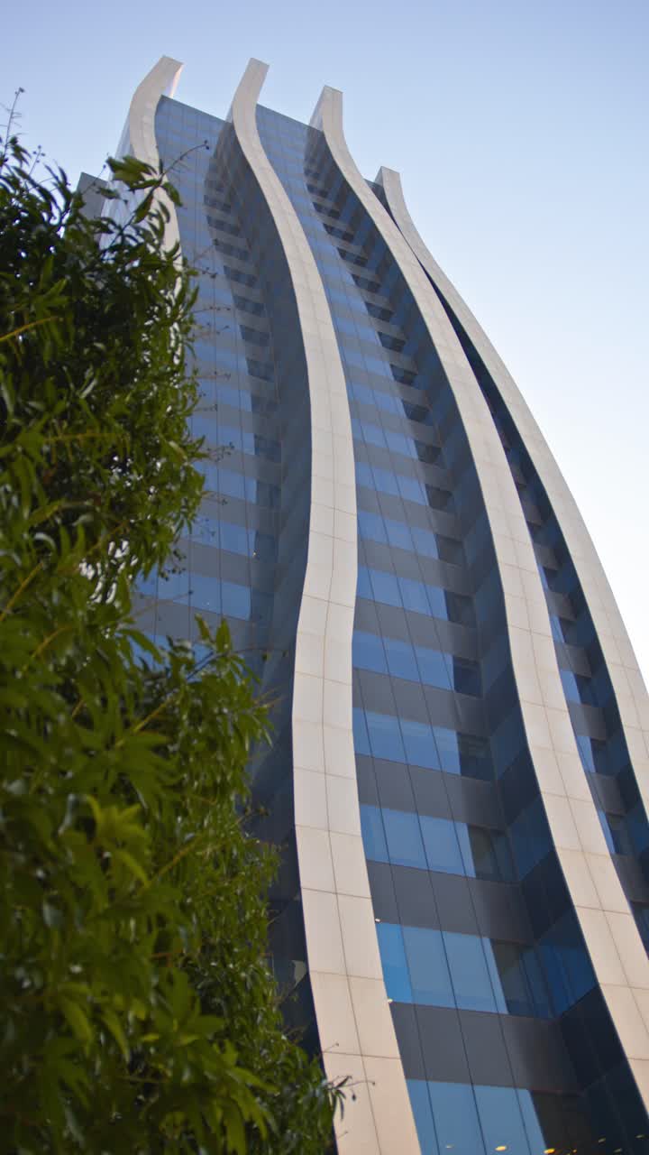 Vertical shot of one of the office towers of the iconic Shopping Paseo La Galería located in Paraguay, featuring an office tower, shopping mall, hotel, and apartment building.
