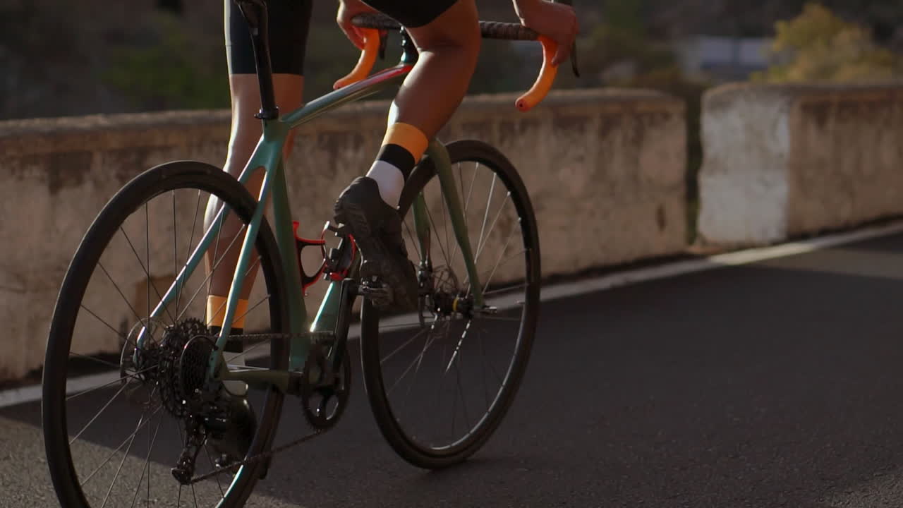 An athlete biking on a mountain serpentine enjoys the stunning view of the island in slow motion, a perfect embodiment of a healthy lifestyle