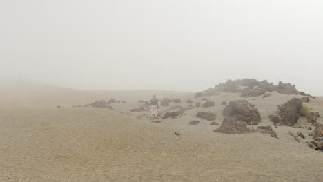 Woman-walking-alone-in-the-mist-at-Teide-National-Park,-static