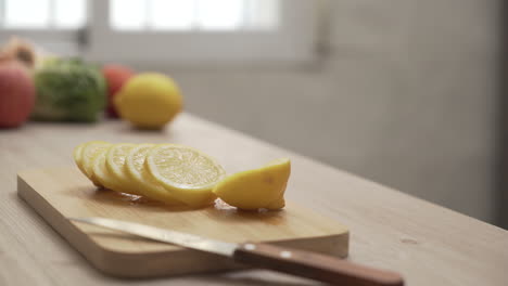 close-up of man adding lemon to tea