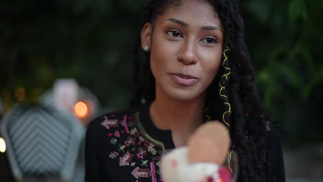 afro latina woman eating ice cream in restaurant