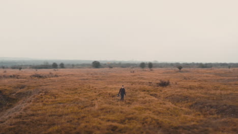 documentarist taking pictures in a vast foggy autumn field,czechia