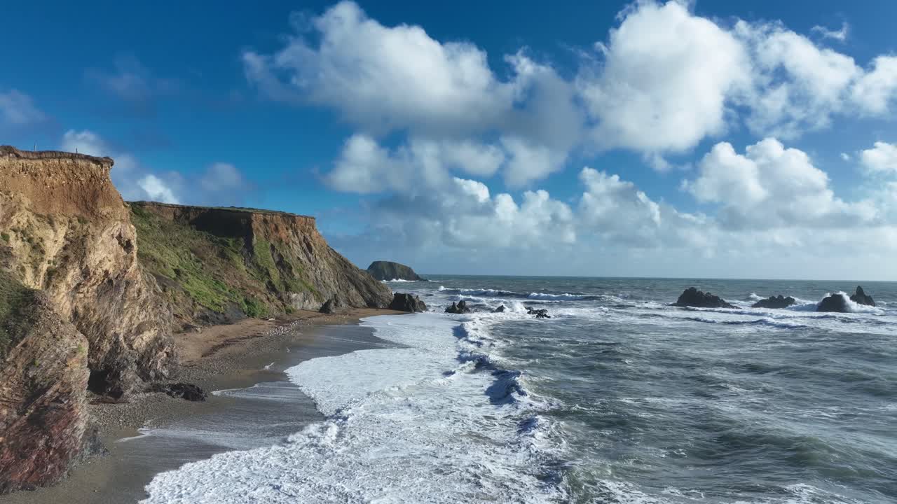 Ireland epic Locations drone flying slowly up beach with waves crashing on beach Kilfarrasy Copper Coast Waterford Ireland wild nature