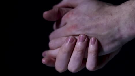 person squeezing some hand sanitiser onto their hands and rubbing them together