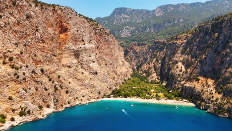 amazing cliff rocks at the coast of the mediterranean sea. approaching picturesque bay with blue calm water at the shore of antalya, turkey. aerial view